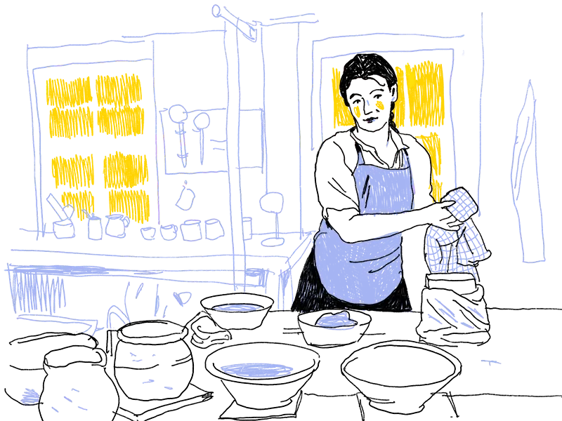 Illustration einer Frau mit dunklem Haar, die hinter einem Tisch steht, auf dem viele Schalen und Gefäße stehen. Im Hintergrund sind Fenster durch die Licht in den Raum fällt. An der Wand hängen weitere Töpereierzeugnisse.
